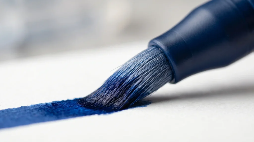 Brush tip marker close-up showing fiber flexibility and ink flow on paper