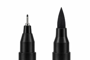 Fine metal-supported point and tapered fibre brush tip on black pen ends