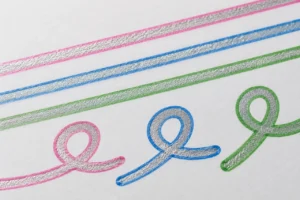 Silver-centred strokes with pink, blue and green outlines on white paper
