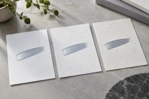 Silver and blue outline strokes on three paper textures